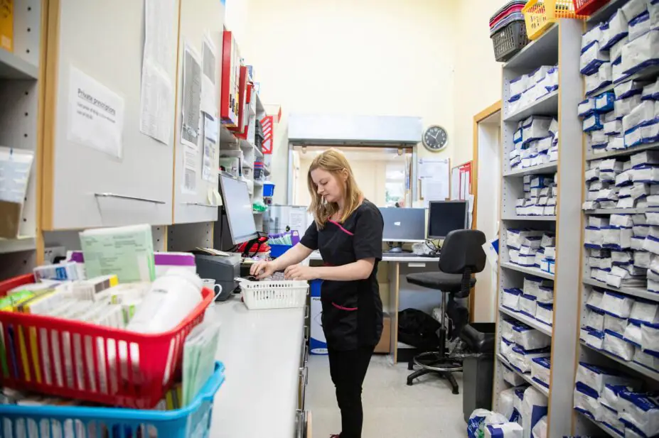 Pharmacist organizing medication in a pharmacy