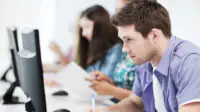 Students take an exam on computers