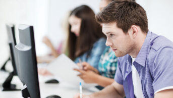 Students take an exam on computers