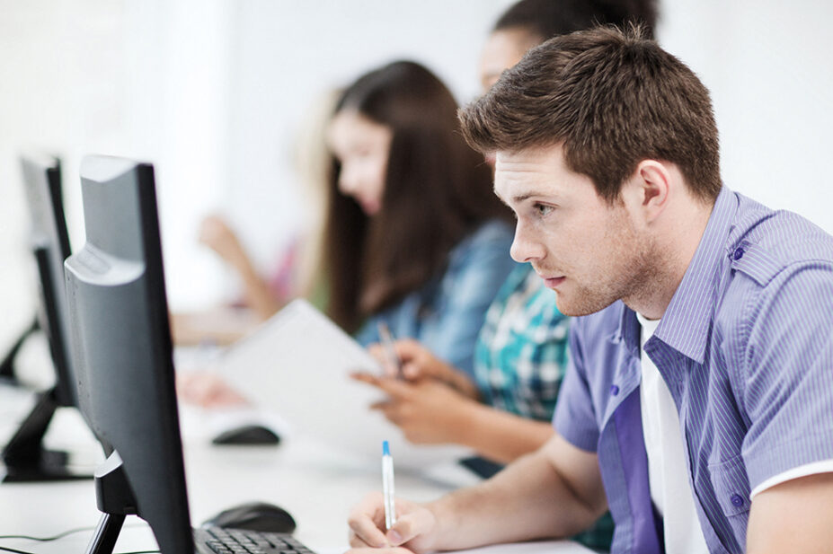 Students take an exam on computers