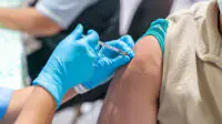 Woman getting vaccinated in arm