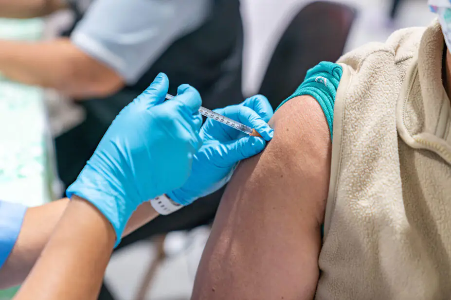 Woman getting vaccinated in arm