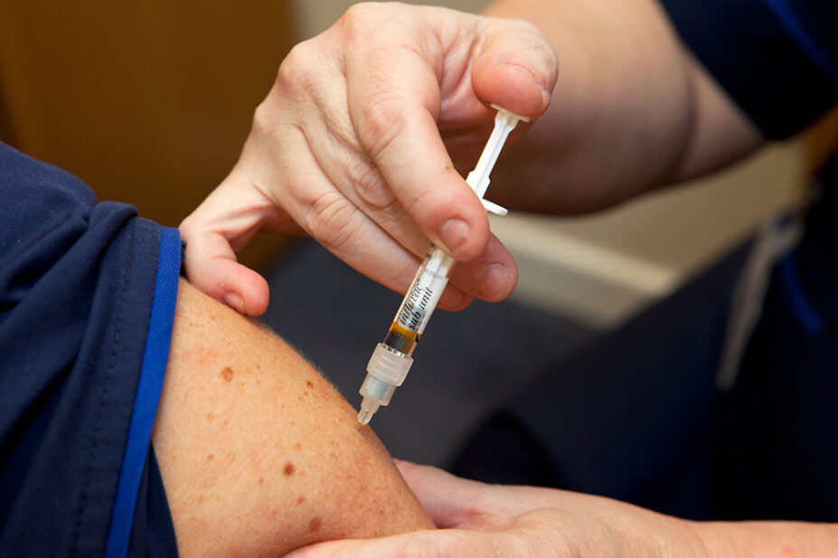 A person receives a vaccination from a healthcare professional