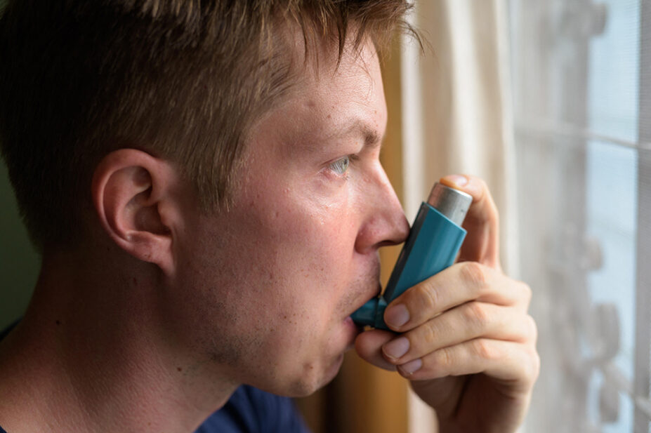 A man uses a pressurised-metered-dose inhaler