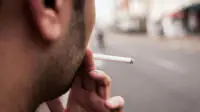 A man smokes a cigarette