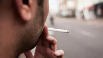 A man smokes a cigarette