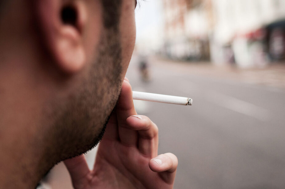 A man smokes a cigarette