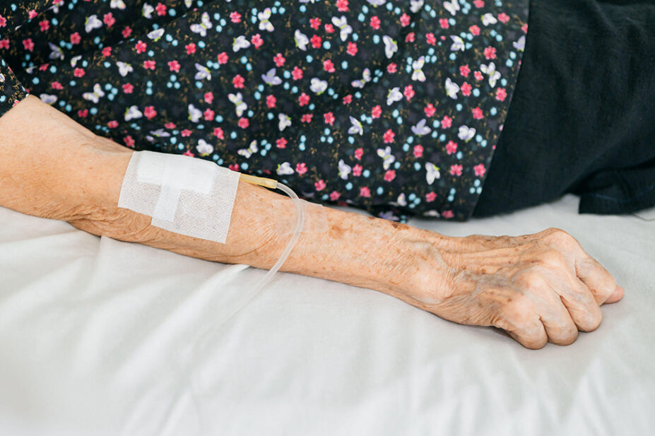 An older woman receives an intravenous treatment