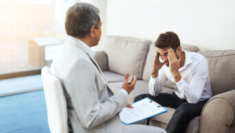 A mental health professional offers a counselling session with a patient