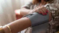 A woman has her blood pressure taken