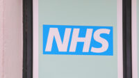 An image of the NHS logo outside one of its buildings
