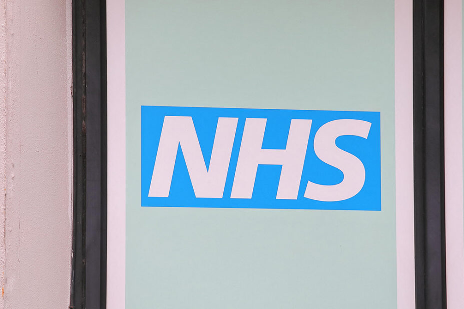 An image of the NHS logo outside one of its buildings