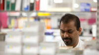 Asian pharmacy worker in dispensary