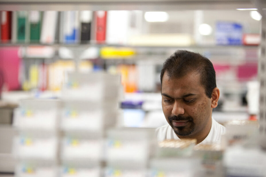 Asian pharmacy worker in dispensary