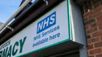 NHS services signage on community pharmacy frontage