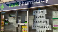 Weight-loss service advertised in pharmacy shop window