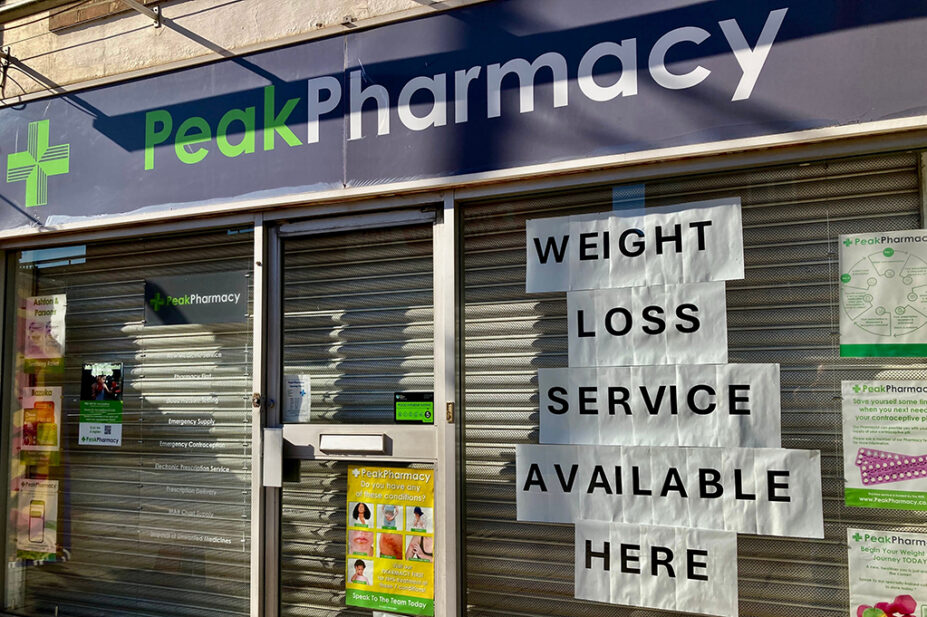 Weight-loss service advertised in pharmacy shop window