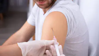 A man receives a vaccination