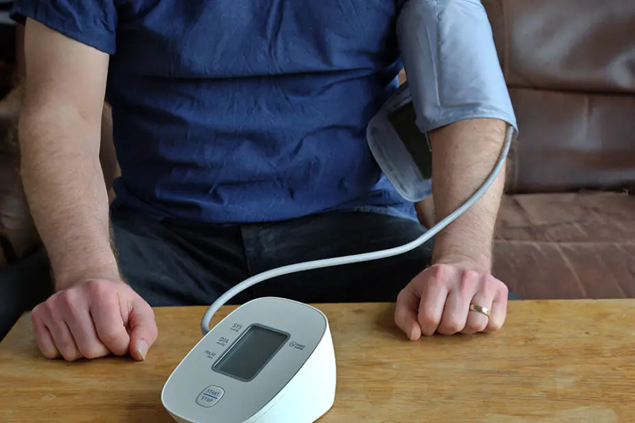 A man checks his blood pressure at home