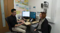 A GP consults with a patient