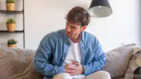 A man suffers from abdominal cramps
