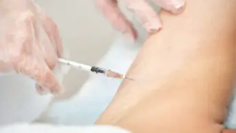 A woman receives a vaccine injection
