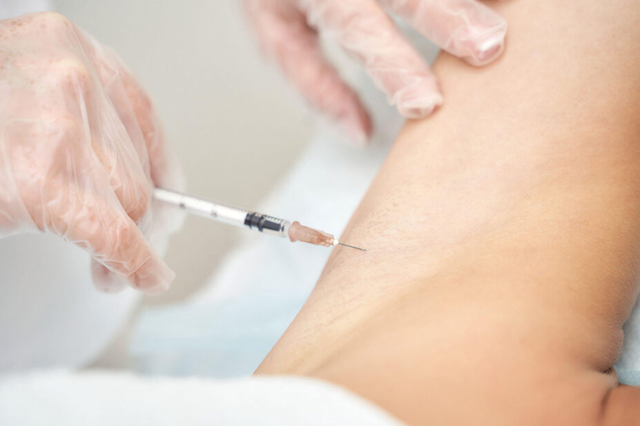 A woman receives a vaccine injection