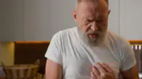 An older man suffers from heartburn