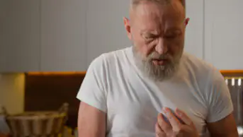 An older man suffers from heartburn
