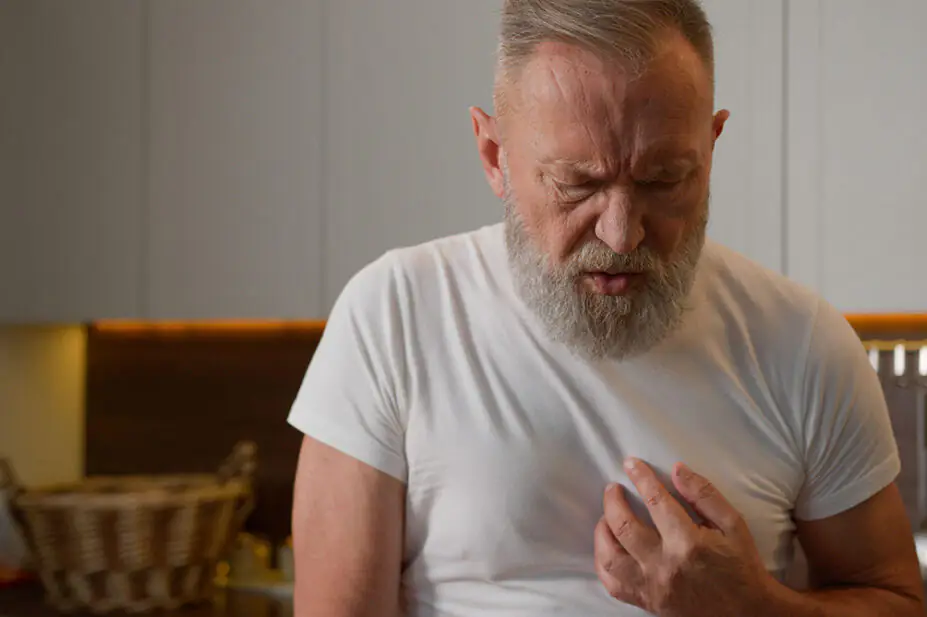 An older man suffers from heartburn