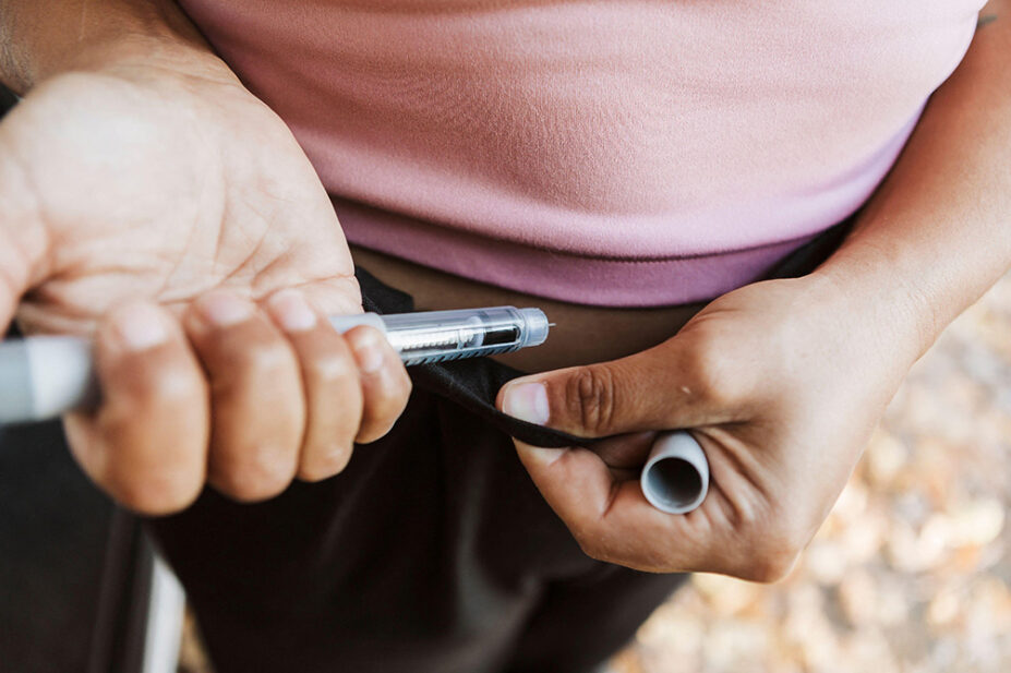 A woman injects herself with a weight-loss pen