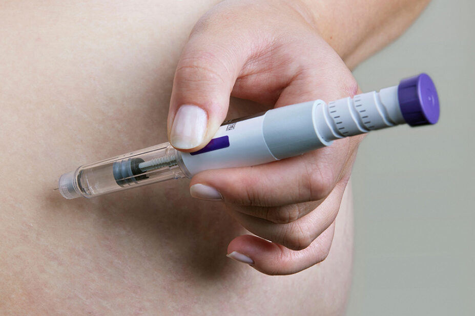A man injects himself with a weight-loss pen