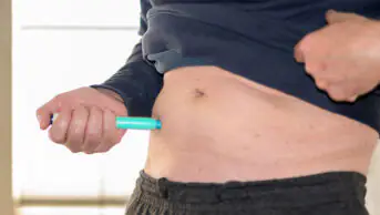 A man injects himself with a weight-loss pen