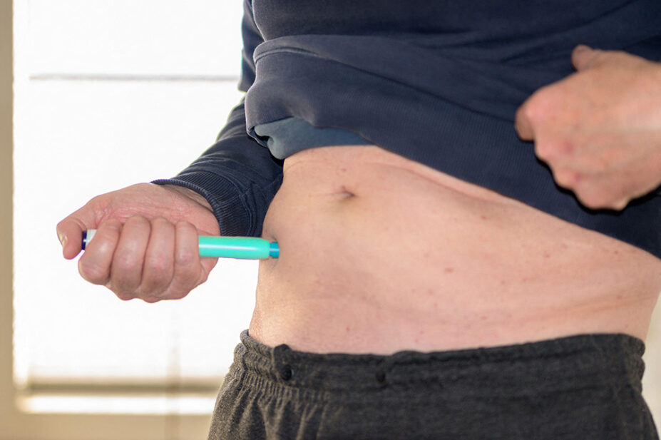 A man injects himself with a weight-loss pen