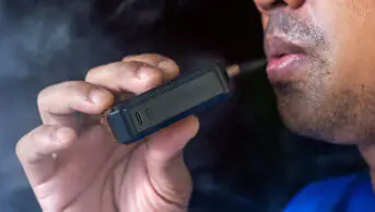 A man smokes a vape