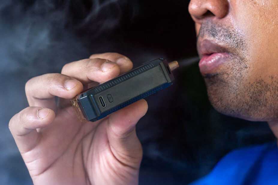 A man smokes a vape