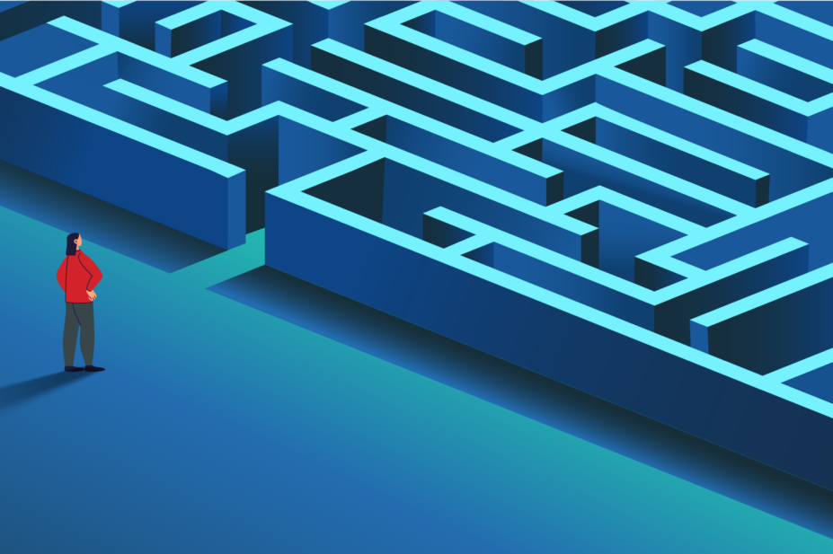Blue floor and maze with person in red top and grey trousers and hair down looking at it from a distance with hands on hips