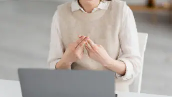 A person uses sign language in a video call