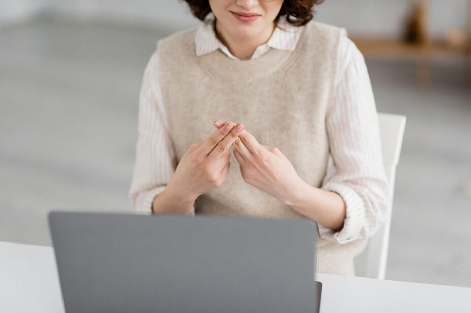 A person uses sign language in a video call