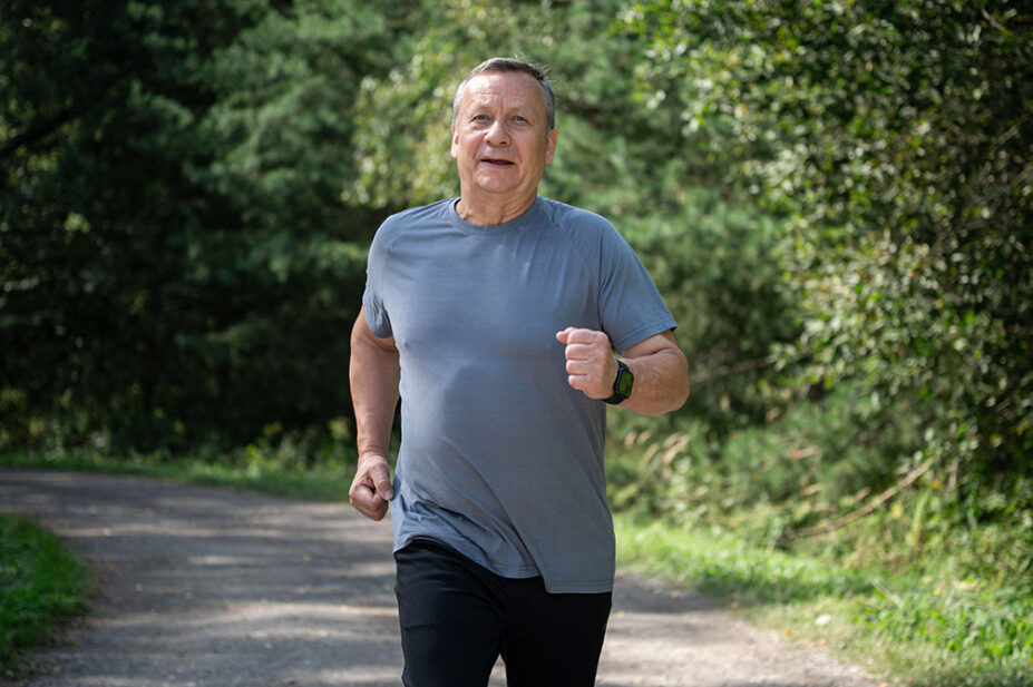 An older man runs outside for exercise