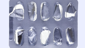 Close up of a empty pill blister on an off-white background