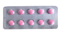 Pink coloured pills packed in blister isolated on white