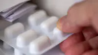 A person holds a blister pack of medicine