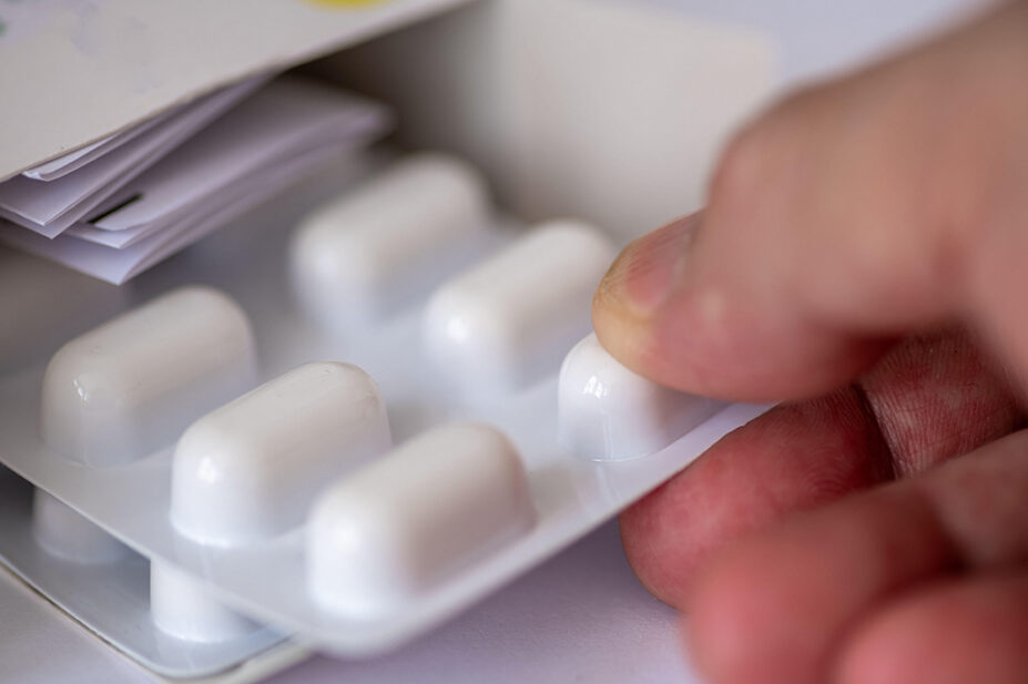 A person holds a blister pack of medicine