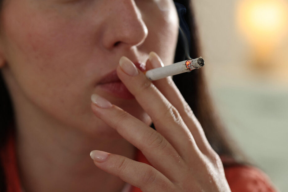 A woman smokes a cigarette