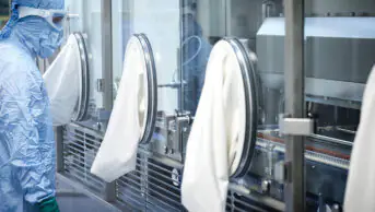 A scientistic works in an aseptic facility