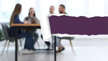 Team of businesspeople working together at table in office, blurred view. Image is torn from right showing a dark purple underneath