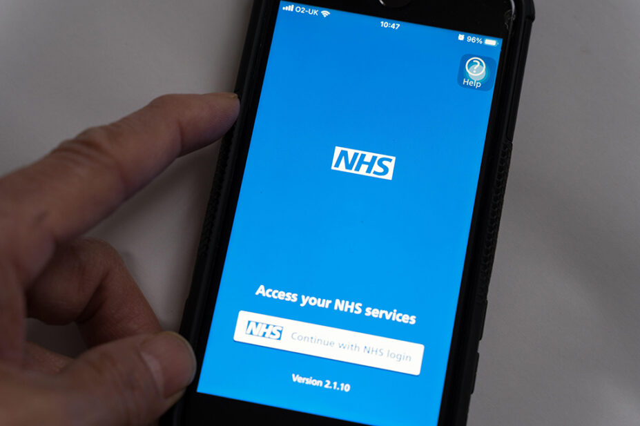 A person uses the NHS App on their smartphone
