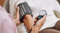 A healthcare professional checks a patient's blood pressure