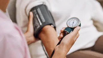 A healthcare professional checks a patient's blood pressure